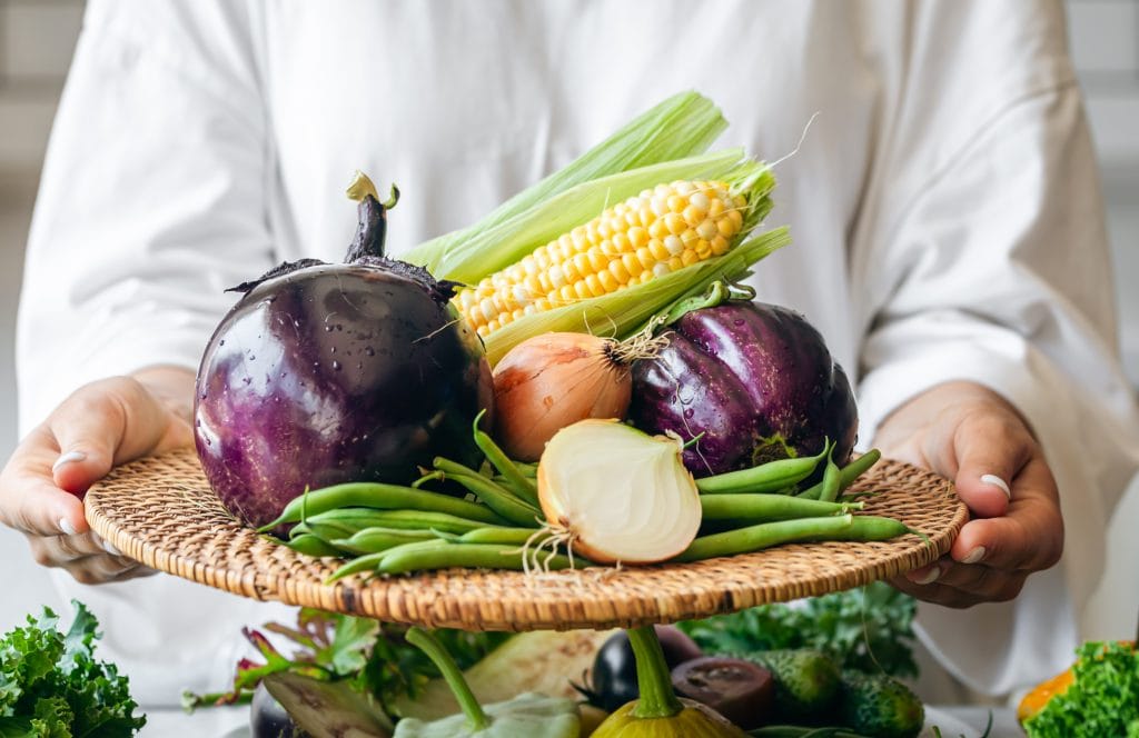 35+ Best Vegetarian Restaurants in Abu Dhabi - Freshest Ingredients, Best Techniques & Indulgent Delicacies 1 Travel to Dubai - 35+ Best Vegetarian Restaurants in Abu Dhabi - Freshest Ingredients, Best Techniques & Indulgent Delicacies - Photo: a woman holds a plate with eggplant onion corn a 2025 03 15 01 33 25 utc 1
