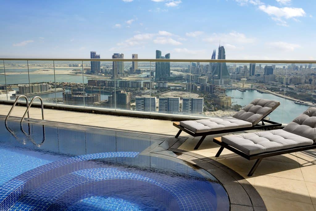 Hilton Bahrain City Centre Hotel & Residences is Officially Open in Manama 4 Travel to Dubai - Hilton Bahrain City Centre Hotel & Residences is Officially Open in Manama - Photo: K1ZVP3 Terrace private pool sunbeds with Skyline view