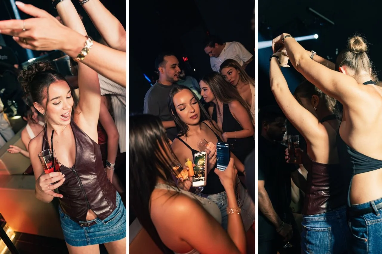 A lively nightclub scene: people dance energetically, holding drinks. Dim lighting and colorful outfits create a vibrant, festive atmosphere.