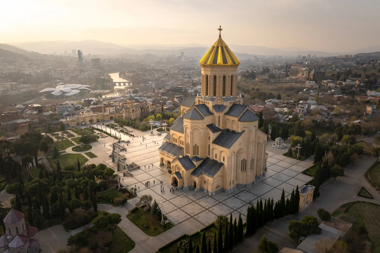 Georgia Tourist Visa for UAE Residents: Complete 2026 Travel Guide 6 Aerial view of Holy Trinity Cathedral of Tbilisi at Sunset Overlooking the Georgian Capital sto