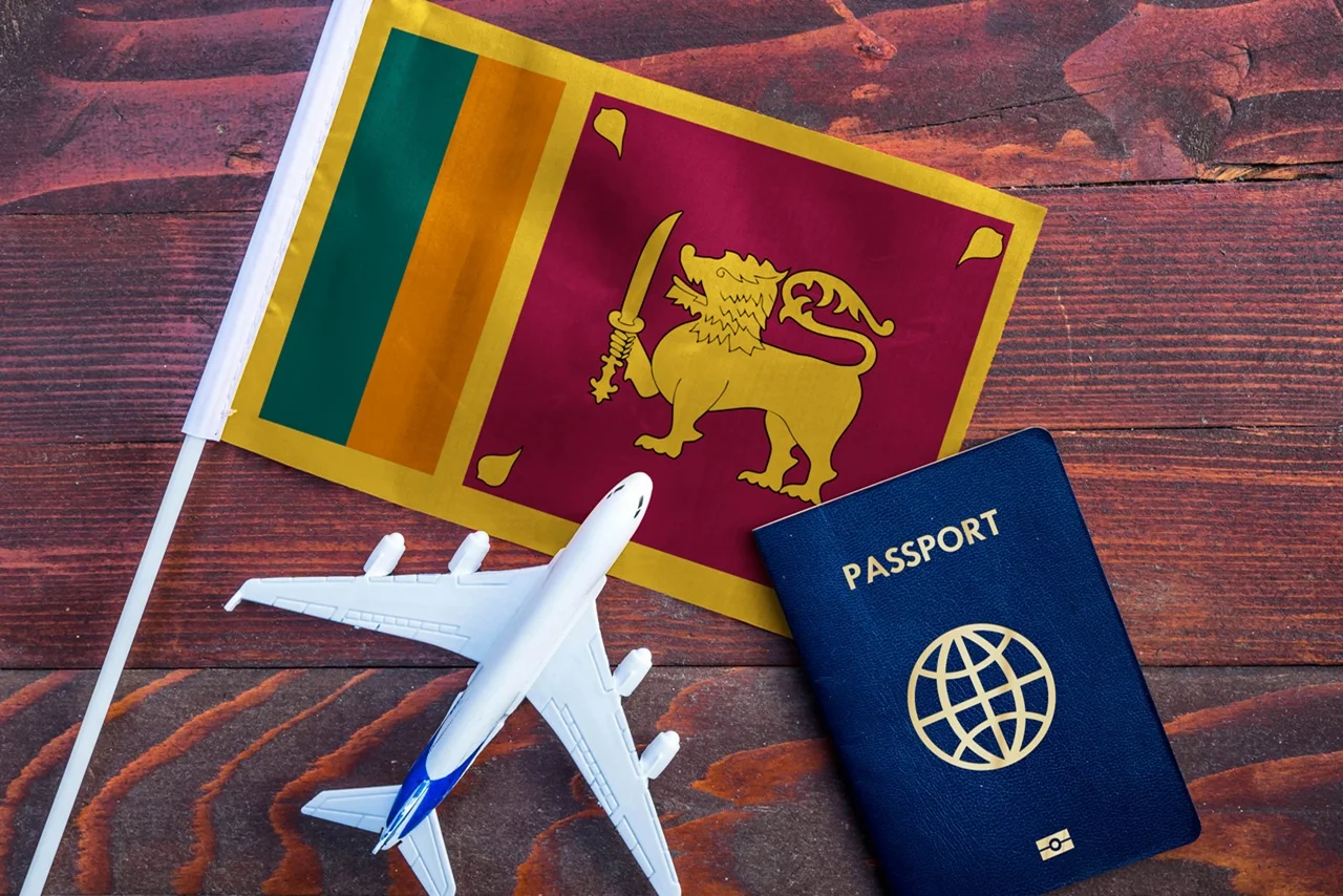 Sri Lanka Visa for UAE Residents in 2026: Complete Guide 2 Flag of Sri Lanka with passport and toy airplane on wooden background.