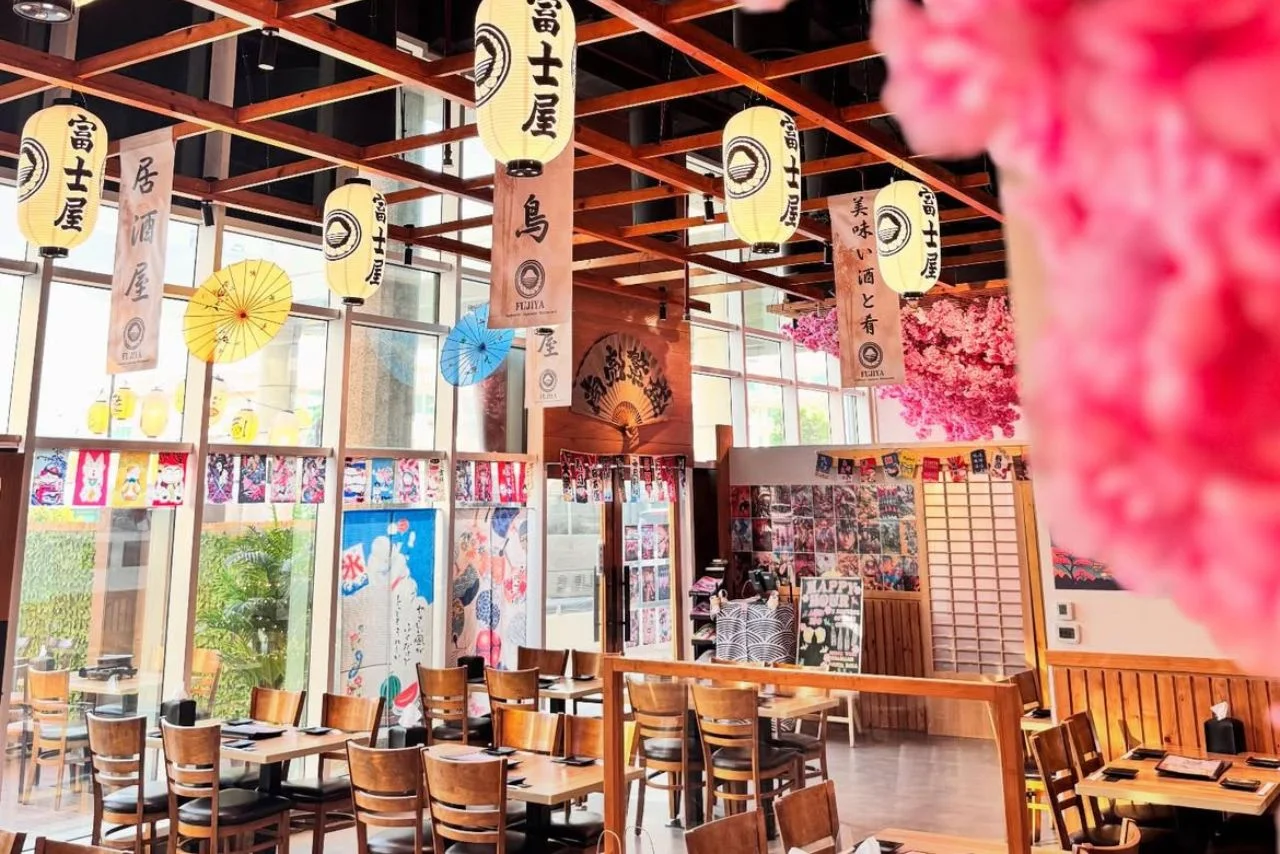 Fujiya Millennium 33 Interior of an authentic Izakaya-style Japanese restaurant featuring wooden tables, hanging paper lanterns, and traditional decorations like colorful umbrellas and banners.