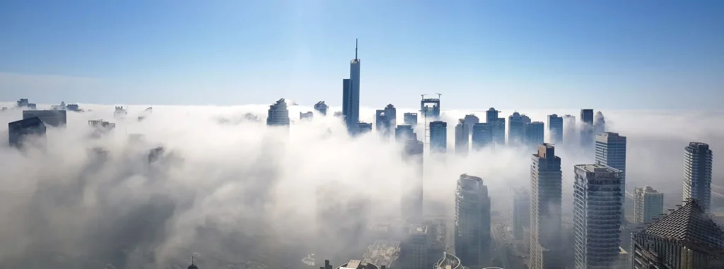 Travel to Dubai - Dubai Weather Guide: Best Months to Enjoy Beaches, Desert Safaris & Festivals  - Photo: fog over the skyscraper buildings in dubai 2026 03 20 00 16 51 utc 1 1